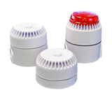 A set of three white audible alarm and strobe units with one having a red cover on top.