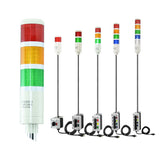 Collection of multicolored industrial signal lights with 3-position switches on a white background