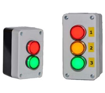 Push button box with multiple colored illuminated lights, power cord and antenna on a white background.