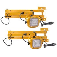 Two yellow industrial lights with metal brackets on a white background