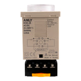 Top perspective of a tan timer with plastic dial at top and black adapter at bottom on a white background.