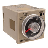 Front angled perspective of a tan industrial timer with black face and red needle on a white background.