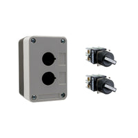 Black and grey push button box with two holes, held together by four phillips head screws next to two black and white 2-position selector switches on a white background.