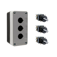 Black and grey push button box with three holes, held together by four phillips head screws next to three black and white 2-position selector switches on a white background.