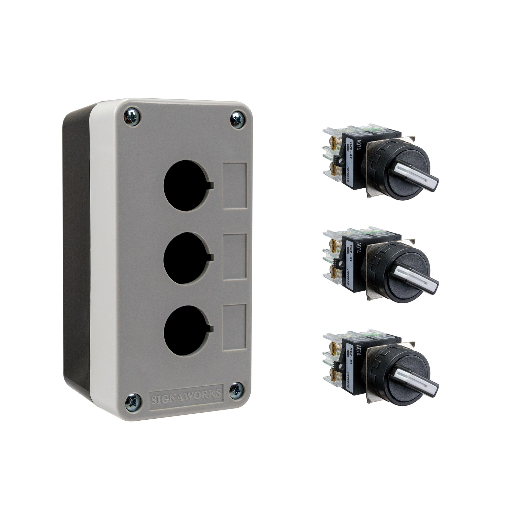 Black and grey push button box with three holes, held together by four phillips head screws next to three black and white 2-position selector switches on a white background.
