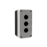 Grey front quarter perspective of a triple push button enclosure with three mounting holes and four phillips head screws holding the enclosure together on a white background.