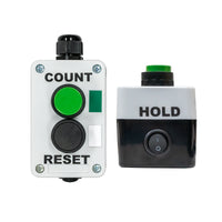 Two angles of a control box with buttons labeled 'Count', 'Hold', and  a switch labeled 'Reset' on a white background.