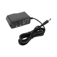 Black power adapter with cable on a white background