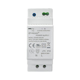 Front perspective of white DIN rail-mounted power supply with adjustment dials and specs label.