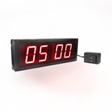 Digital clock with red LED display on a white background