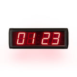 Digital clock with red LED display on a white background.