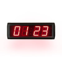 Digital clock with red LED display on a white background