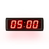 Digital clock with red LED display on a white background.