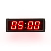 Digital clock with red LED display on a white background.