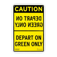 Yellow and black sign with mirrored text on top half stating, "DEPART ON GREEN ONLY."