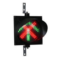 A 12 inch diameter 2-in-1 lens LED traffic light with red X and green arrow signals, mounted on a black housing with two steel right angle mounting brackets.