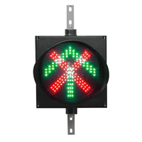 A 12 inch diameter 2-in-1 lens LED traffic light with red X and green arrow signals, mounted on a black housing with two steel right angle mounting brackets.
