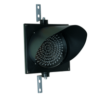 A 12 inch diameter 2-in-1 lens LED traffic light mounted on a black housing with two steel right angle mounting brackets.