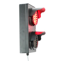 Angled perspective of a black four inch 2-light traffic light with red illuminated LEDs on a white background.