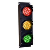 Triple red, amber and green traffic light on a white background.
