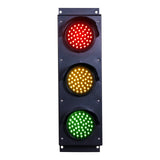Triple red, amber and green traffic light on a white background.