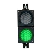 Green four inch traffic light with black plastic housing and mounting brackets.