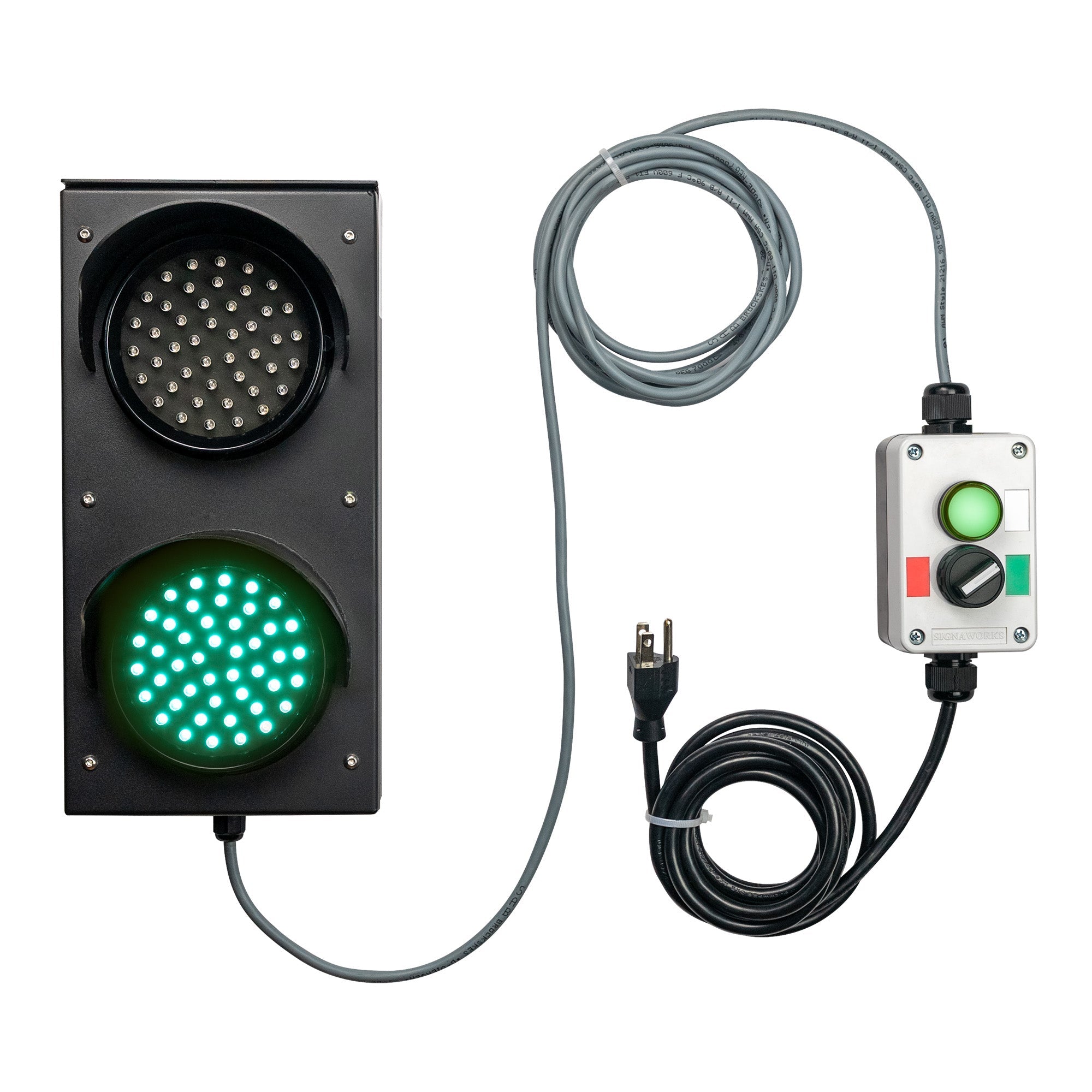 Front perspective of a black four inch 2-light traffic light with green illuminated, mirrored by a green illuminated pilot light on a connected 2-position switch control box. A grey cable connects the two units with a black 3-prong power cord coming from the bottom of the control box.