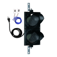 Black wireless 8 inch traffic light with white wireless key fob on a white background.