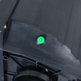 Close up of green power button on black polycarbonate traffic light.