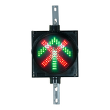 An 8 inch diameter LED traffic light signal featuring a red X and green arrow in a black polycarbonate housing on a white background.