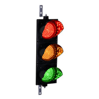 A vertical LED traffic light with three lenses, featuring red, amber, and green lights, mounted on a black housing with a mounting bracket on top and bottom.