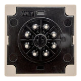 Rear of tan timer with black face and 8 metal pins on a white background.