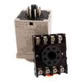 Tan timer with black adapter base leaning against it on a white background.